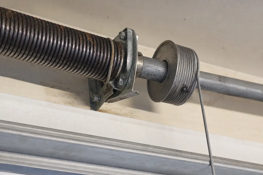 Torsion spring, shaft and cable drum above a garage door in New Haven, CT